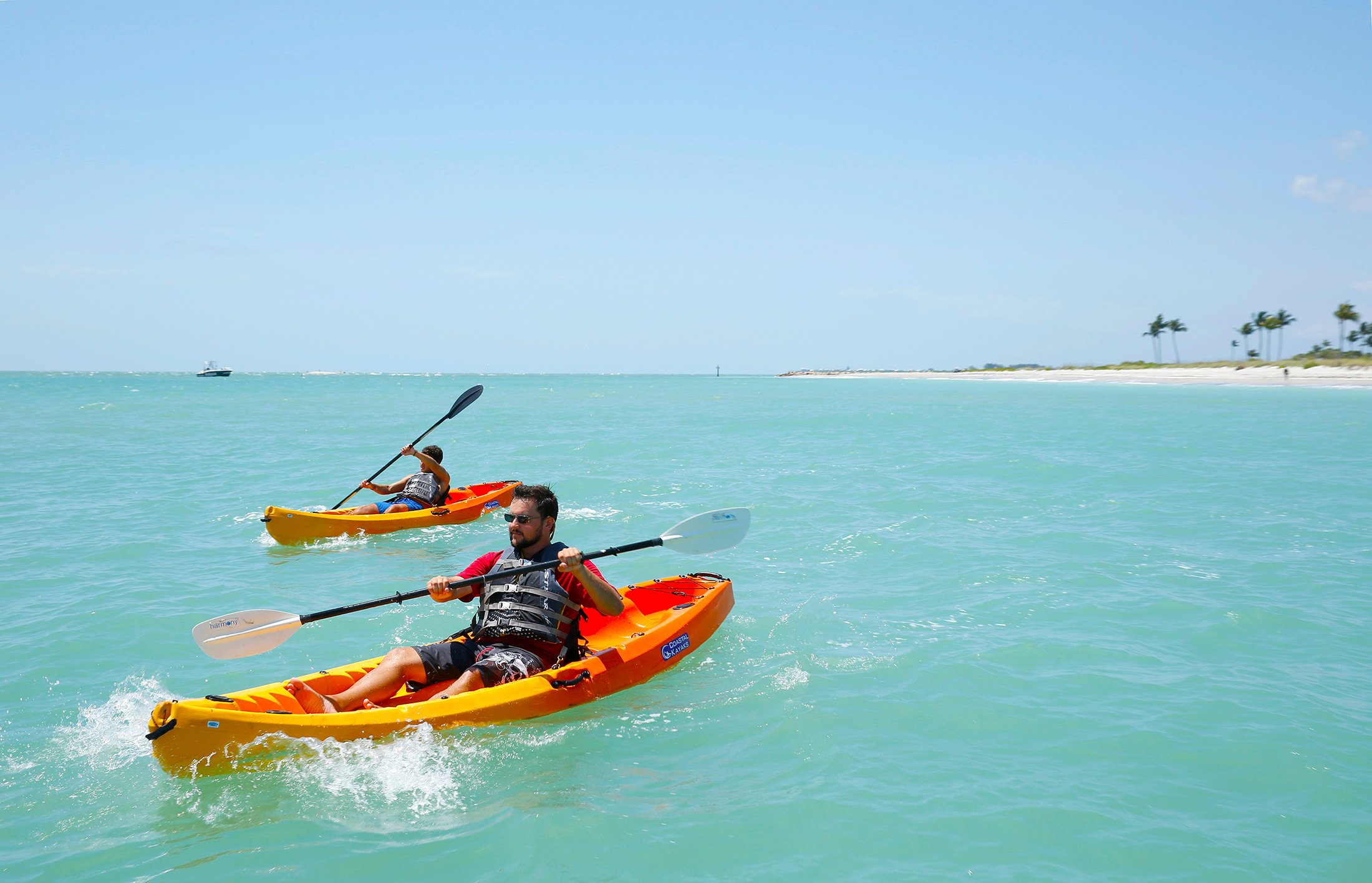 Two people kayaking off the shores of Sanibel Island.