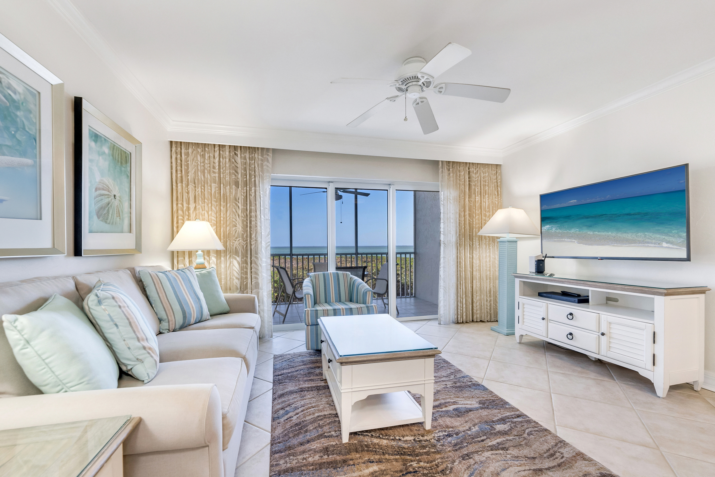 Bright and cozy living room with ocean views and beachy decor