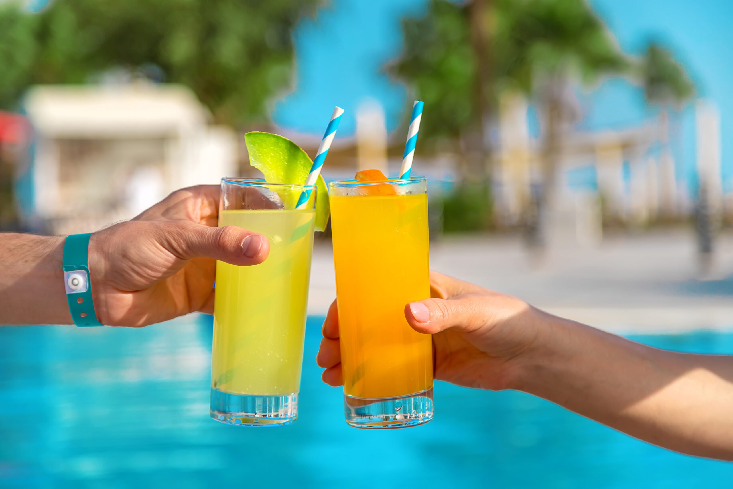 Two cocktail and background of swimming pool