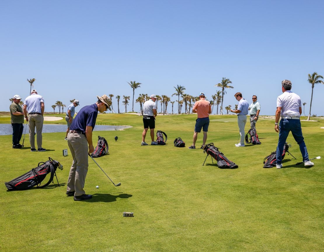 Group of golfers practicing on a sunny course