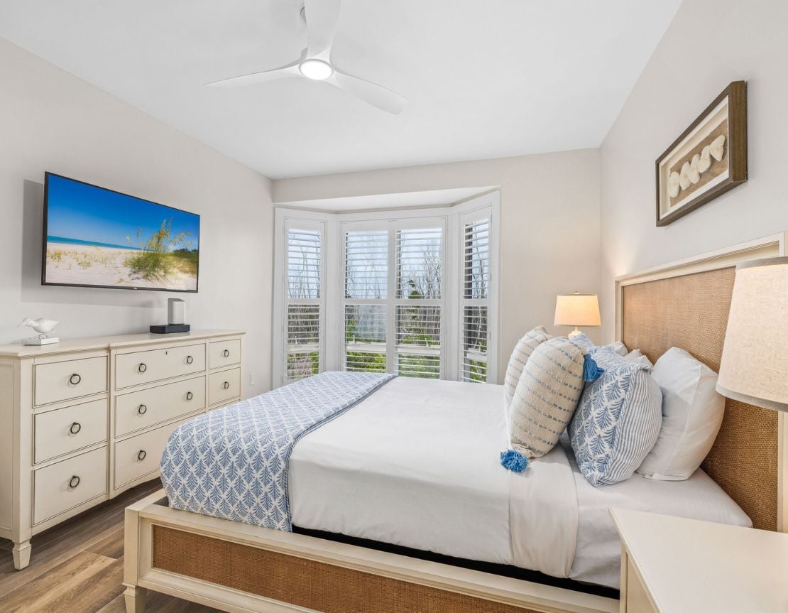 Bright and cozy bedroom with a beachy feel and a large window view