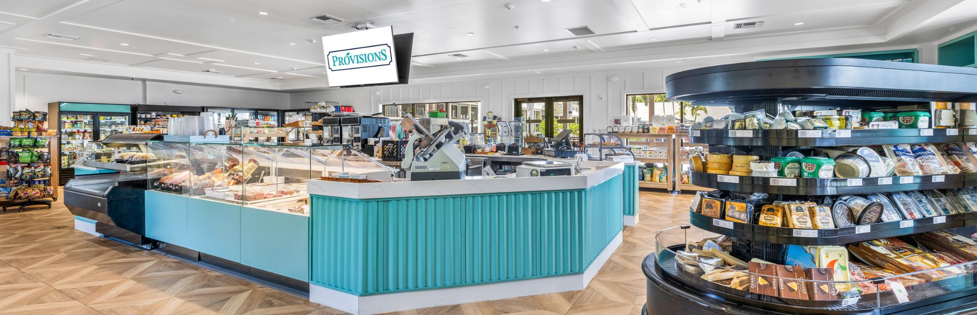 Inside view of a resort market with snacks and fresh food counters