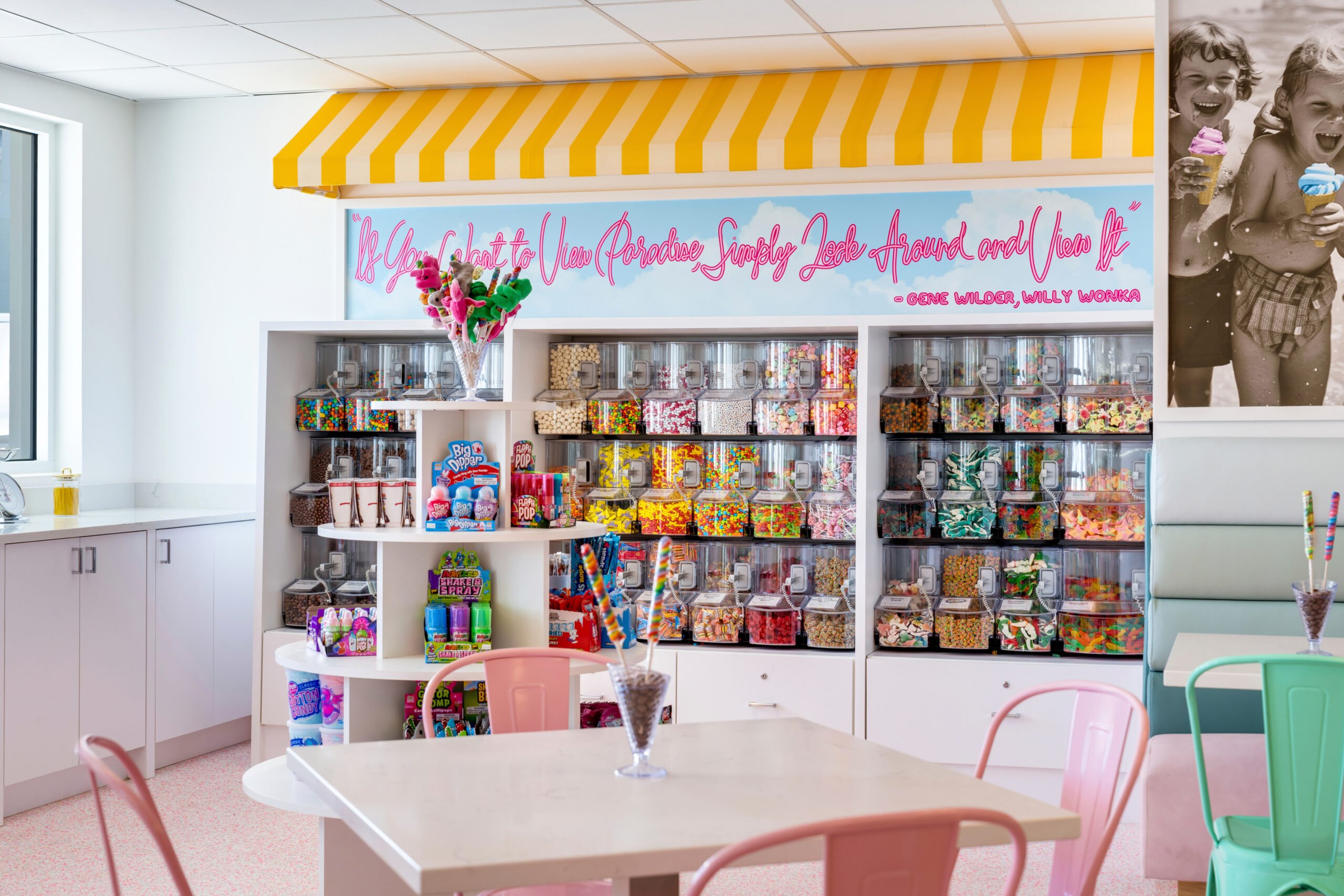Colorful candy shop interior with jars and pink chairs