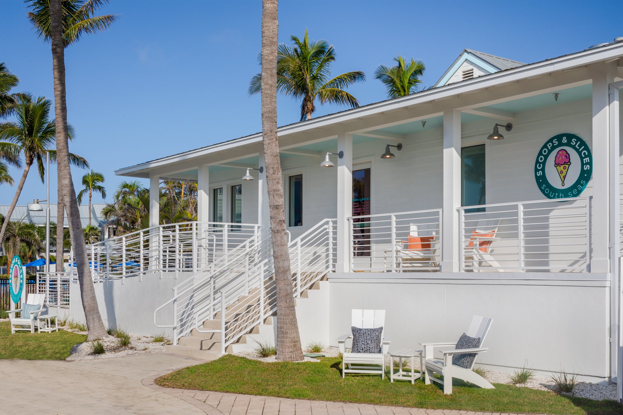 Coastal style ice cream shop with white exterior and palm trees