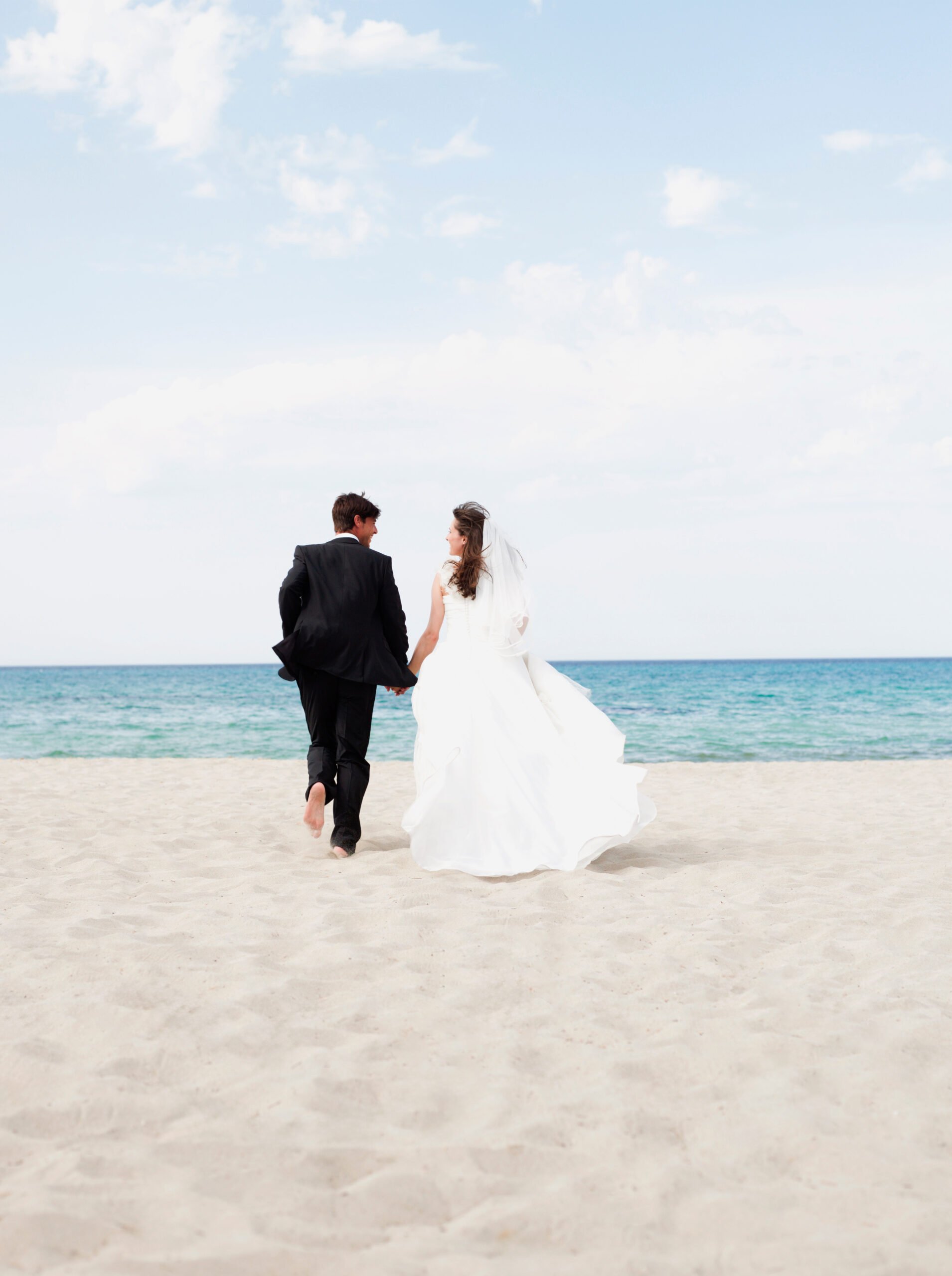 Bride and Groom walking along beach