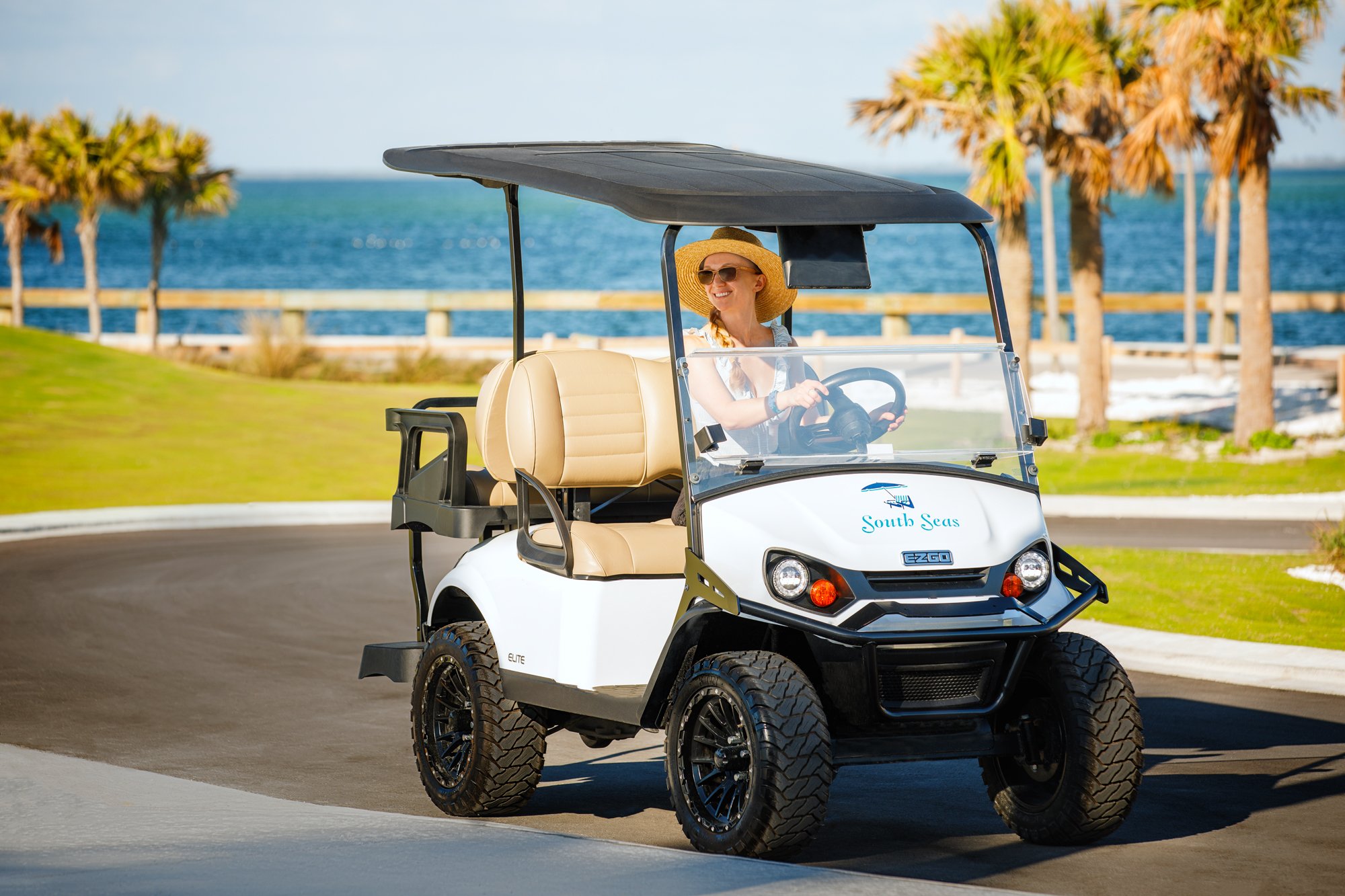 Guest driving a golf cart at South Seas